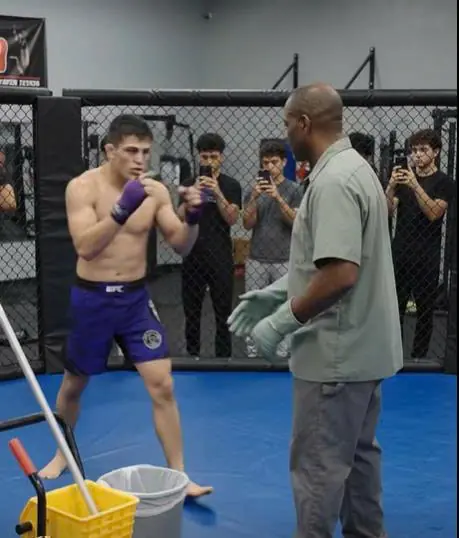A Rich Kid Challenged the Quiet Janitor to Spar — Then the Janitor Took Off His Work Shirt and Stepped Into the Cage